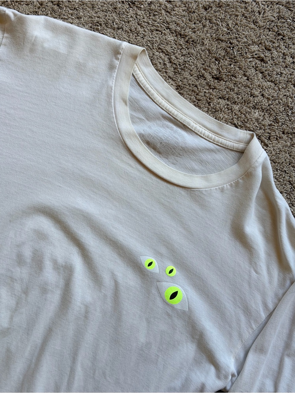 Invisible Creature Men's White Spooky Graphic Long Sleeve Tee with Neon Eyes